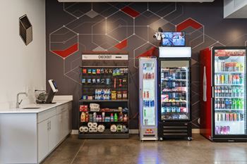 A modern convenience store with a variety of drinks and a self-service area.